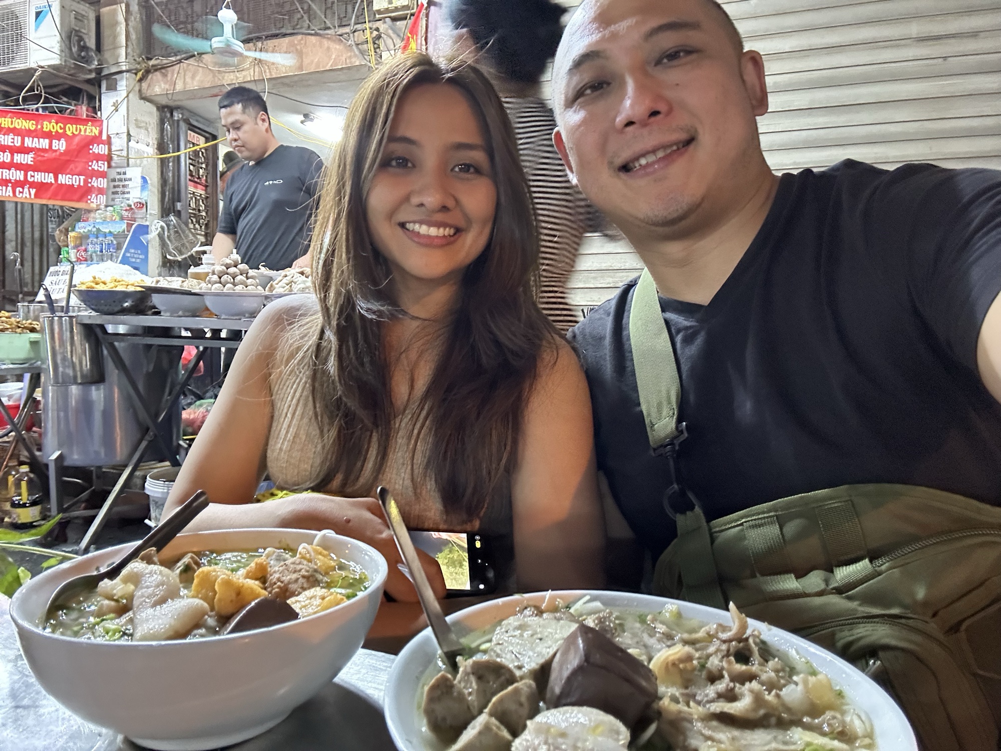 David and Chai at a street food stall in Vietnam.